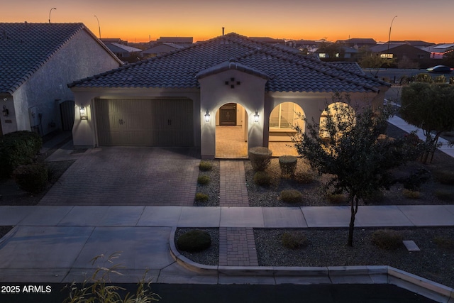 mediterranean / spanish-style house featuring a garage