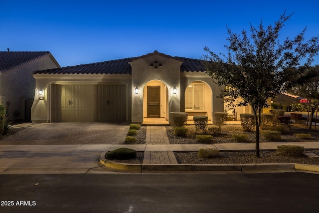 mediterranean / spanish house featuring a garage