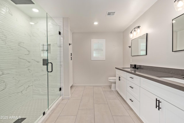 bathroom featuring double vanity, visible vents, toilet, a sink, and a shower stall