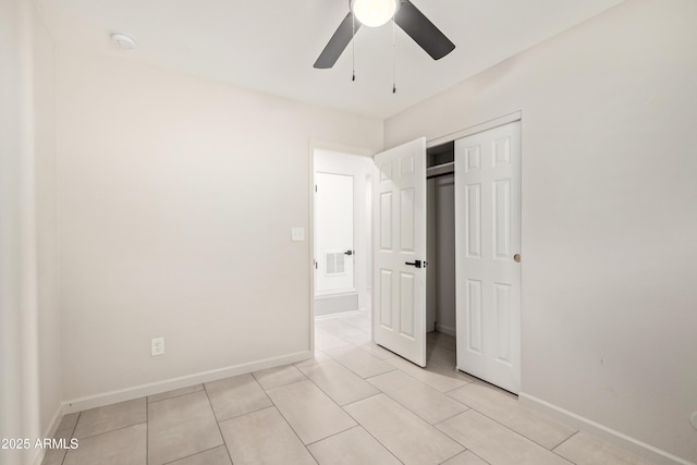 unfurnished bedroom featuring light tile patterned floors, baseboards, visible vents, and a closet