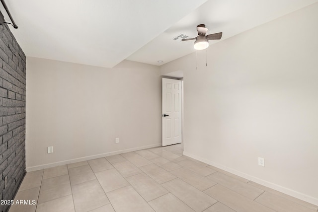 unfurnished room with baseboards, brick wall, visible vents, and a ceiling fan