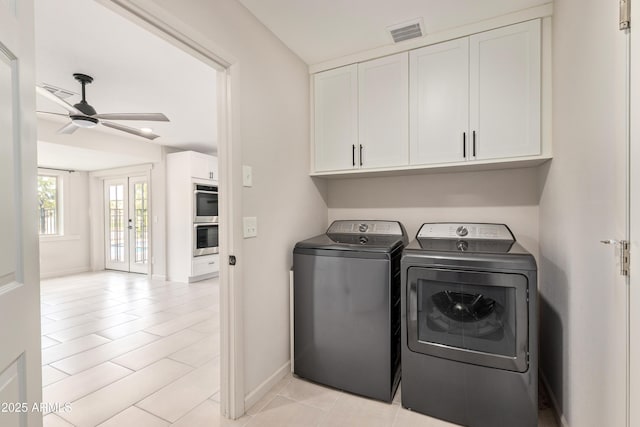 laundry room with cabinet space, visible vents, a ceiling fan, independent washer and dryer, and baseboards