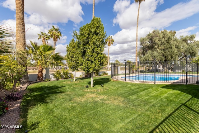 view of yard featuring fence and a fenced in pool