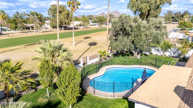 view of swimming pool with a lawn, fence, and a fenced in pool