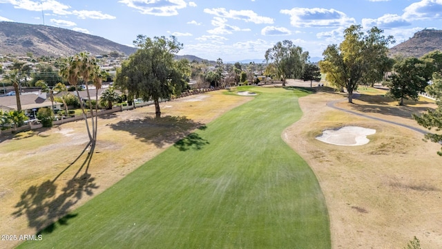 surrounding community with view of golf course and a mountain view