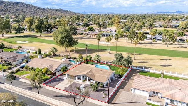 drone / aerial view featuring view of golf course, a residential view, and a mountain view