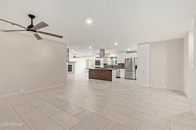 unfurnished living room featuring ceiling fan, baseboards, a glass covered fireplace, and recessed lighting