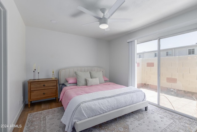 bedroom with access to exterior, hardwood / wood-style flooring, and ceiling fan