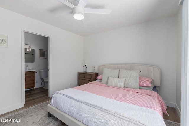 bedroom with connected bathroom, ceiling fan, and light wood-type flooring