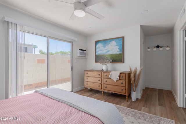 bedroom with ceiling fan, light hardwood / wood-style floors, access to exterior, and a wall mounted AC