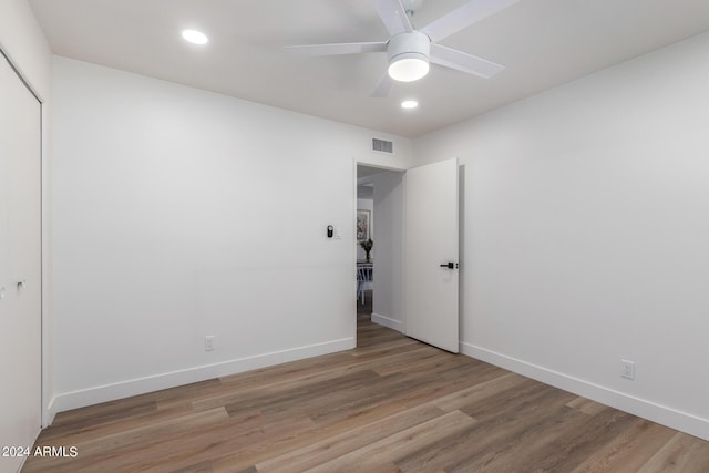 unfurnished bedroom with light wood-type flooring, a closet, and ceiling fan