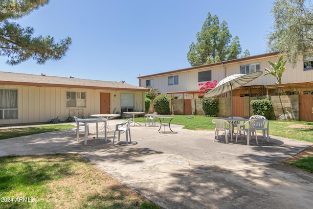 back of house with a yard and a patio