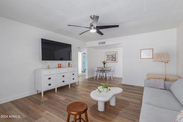 living room with ceiling fan and light hardwood / wood-style floors