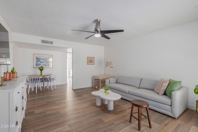 living room with ceiling fan and light wood-type flooring