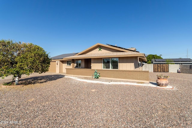 ranch-style house with solar panels