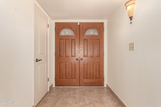 doorway with light tile patterned floors