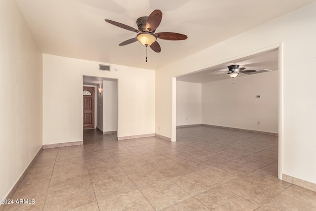 tiled empty room with ceiling fan