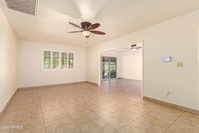 tiled empty room with ceiling fan