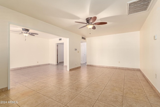 empty room featuring light tile patterned floors and ceiling fan