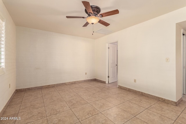 spare room with ceiling fan and light tile patterned floors