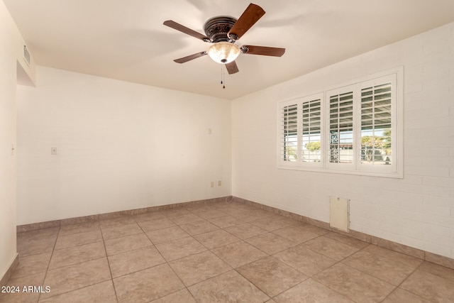 unfurnished room with light tile patterned floors and ceiling fan