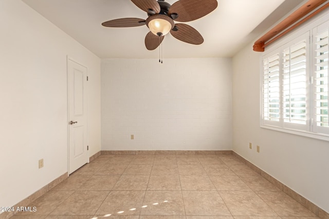 tiled empty room with ceiling fan