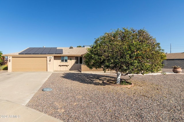 view of front of house with solar panels and a garage