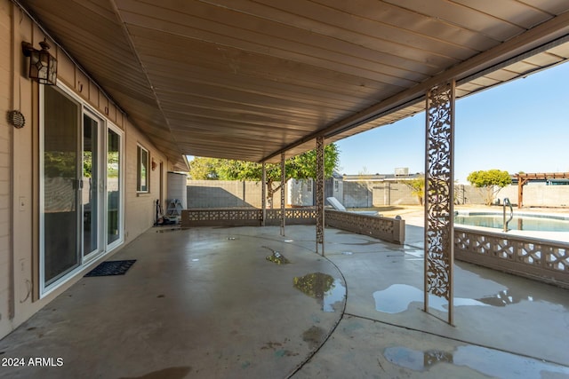 view of patio with a fenced in pool