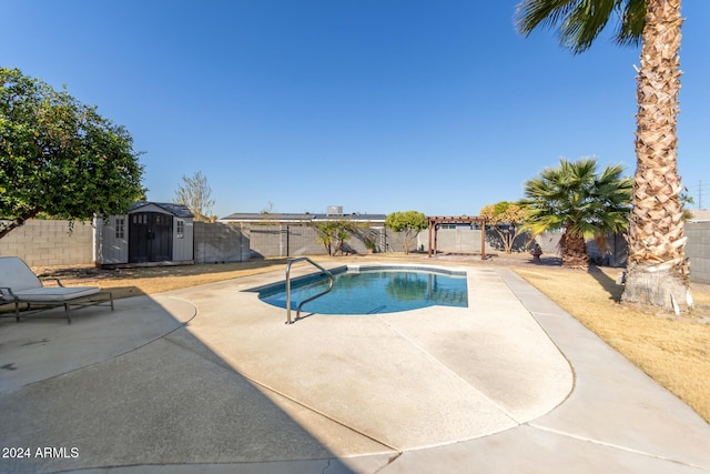 view of swimming pool featuring a storage unit and a patio area