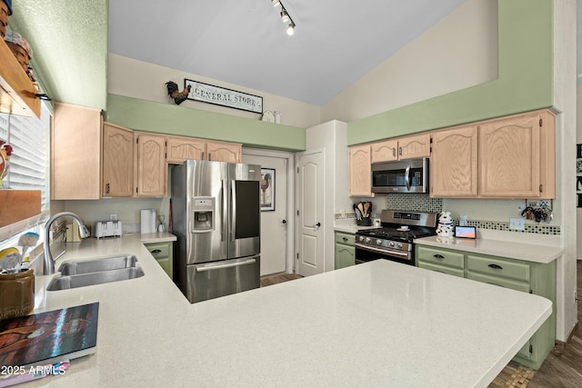 kitchen with sink, backsplash, stainless steel appliances, light brown cabinetry, and kitchen peninsula