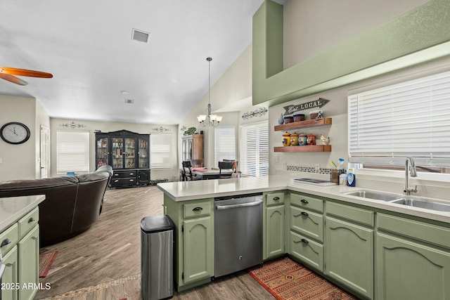 kitchen featuring dark hardwood / wood-style floors, kitchen peninsula, sink, stainless steel dishwasher, and green cabinetry