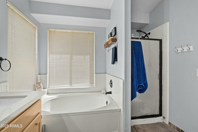 bathroom featuring vanity and separate shower and tub