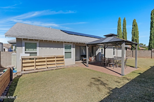 rear view of property with a yard, a gazebo, and a patio area