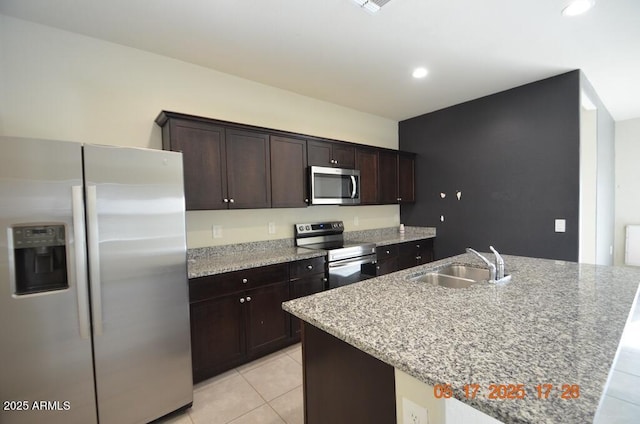 24646 N Barley Rd, Florence, AZ 85132 - kitchen featuring stainless steel appliances, a sink, light tile patterned floors, dark brown cabinetry, and recessed lighting
