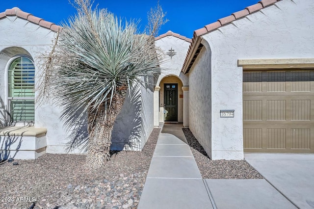 doorway to property featuring a garage