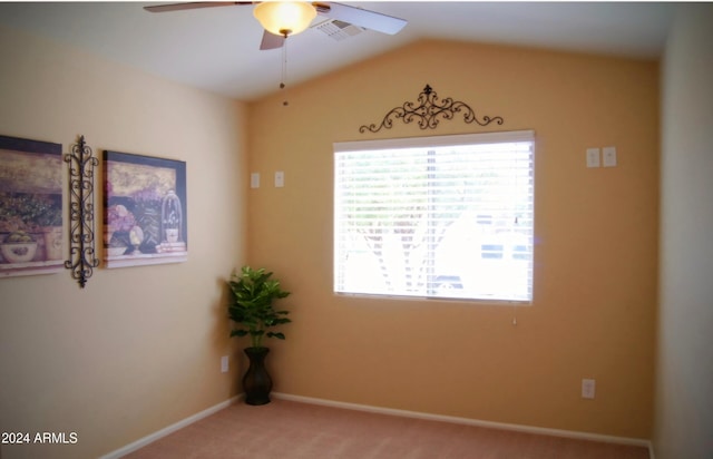 carpeted spare room featuring ceiling fan and lofted ceiling