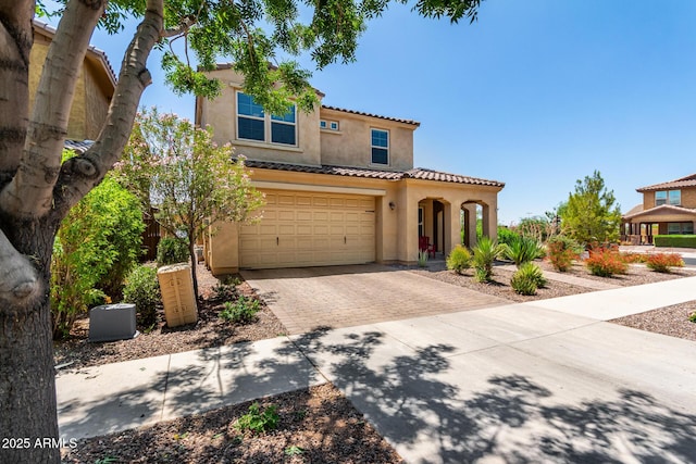 5016 S Curie Way, Mesa, AZ 85212 - mediterranean / spanish-style home featuring stucco siding, decorative driveway, a tile roof, and an attached garage
