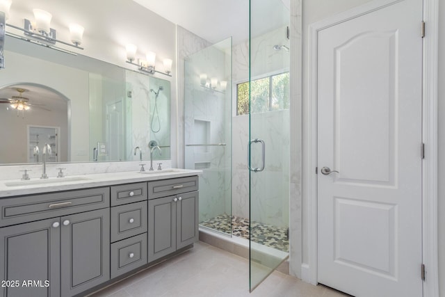 bathroom with vanity, a shower with shower door, tile patterned floors, and ceiling fan