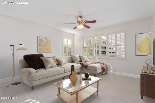 living room featuring a healthy amount of sunlight and ceiling fan