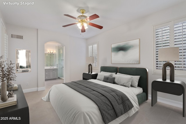 bedroom featuring ceiling fan and connected bathroom