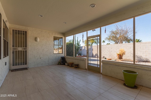 unfurnished sunroom featuring a healthy amount of sunlight