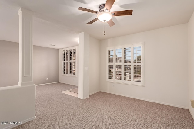 unfurnished room with ceiling fan and carpet