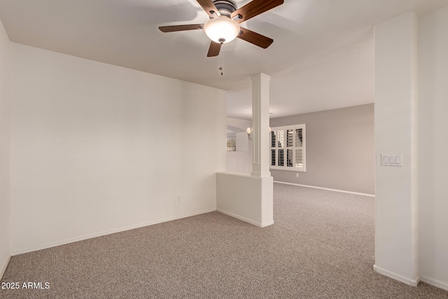 carpeted empty room with ceiling fan and ornate columns