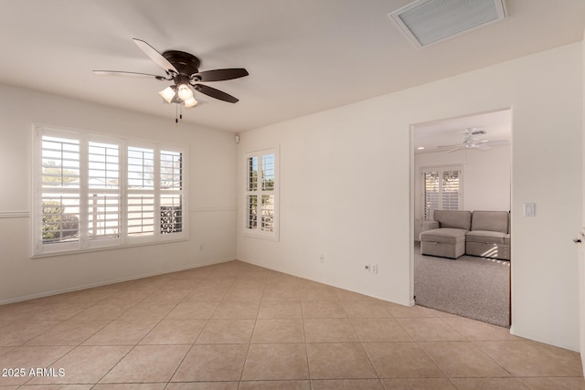 unfurnished room featuring ceiling fan and light tile patterned floors