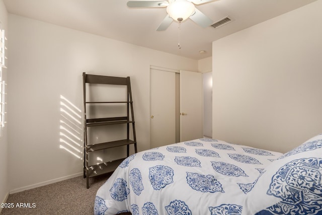 carpeted bedroom featuring a closet and ceiling fan