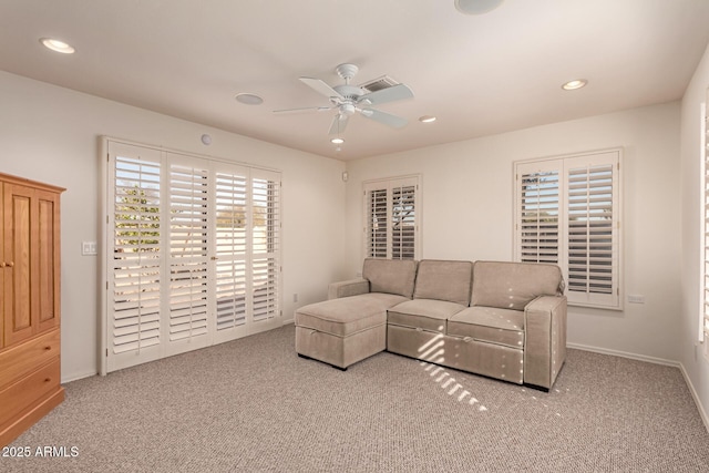 living room featuring ceiling fan and light colored carpet