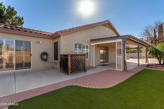 back of property featuring a yard and a patio