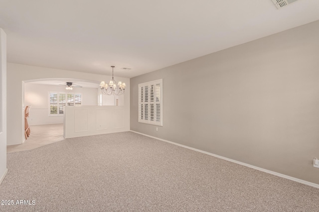 unfurnished room with ceiling fan with notable chandelier and light carpet