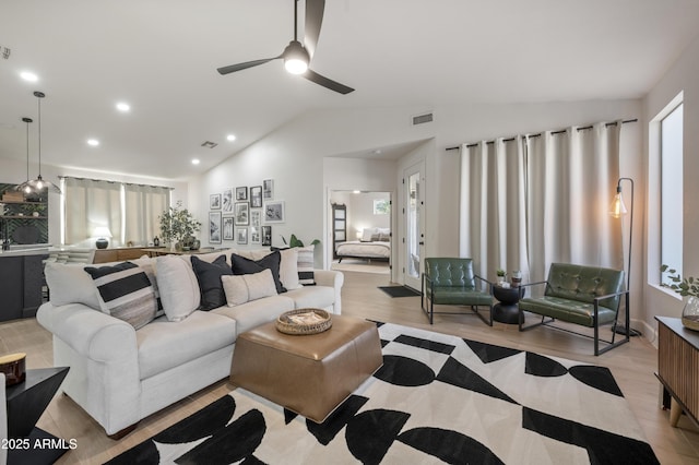 living area with visible vents, recessed lighting, ceiling fan, vaulted ceiling, and light wood-type flooring