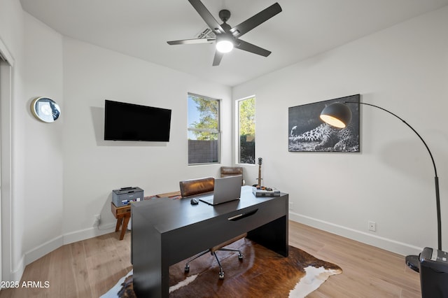 office space with a ceiling fan, baseboards, and wood finished floors